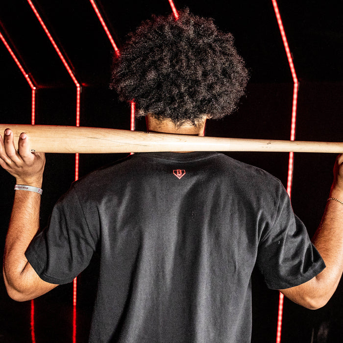 Adult model wearing black graphic tee with "Atlanta Braves Upside Down" design