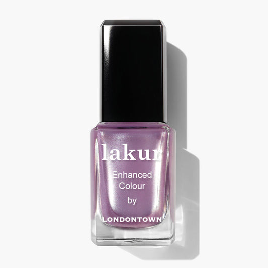 Close-up of a bottle of LONDONTOWN nail polish named "Amethyst On Ice" in a frosty lavender shade with a black cap, branded "Enhanced Colour.
