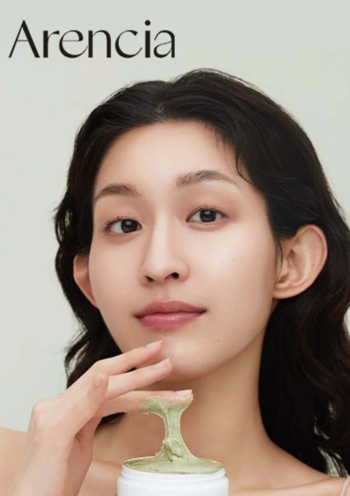 Woman holding a green facial product with 'Arencia' branding