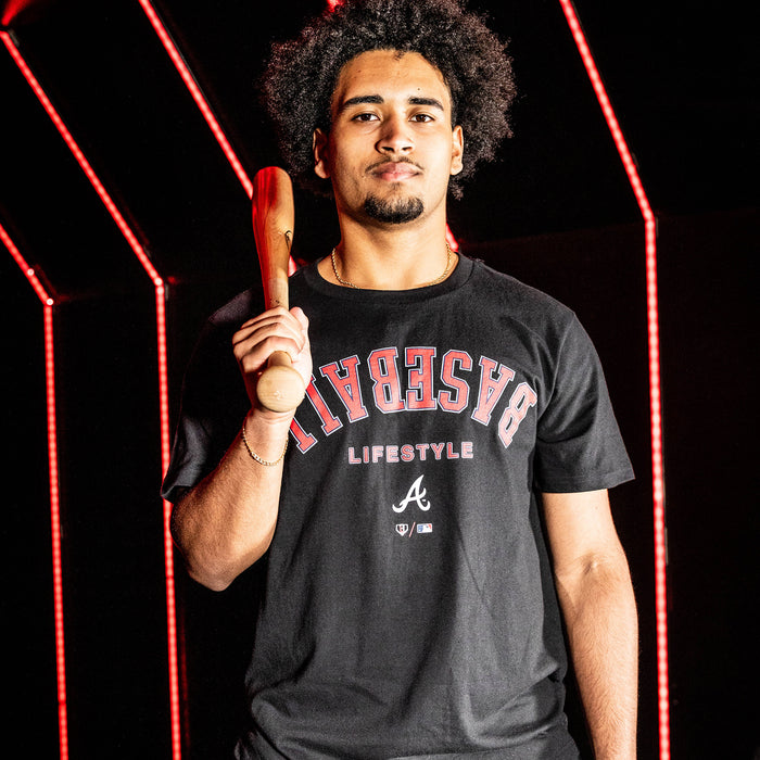 Adult model wearing black graphic tee with "Atlanta Braves Upside Down" design