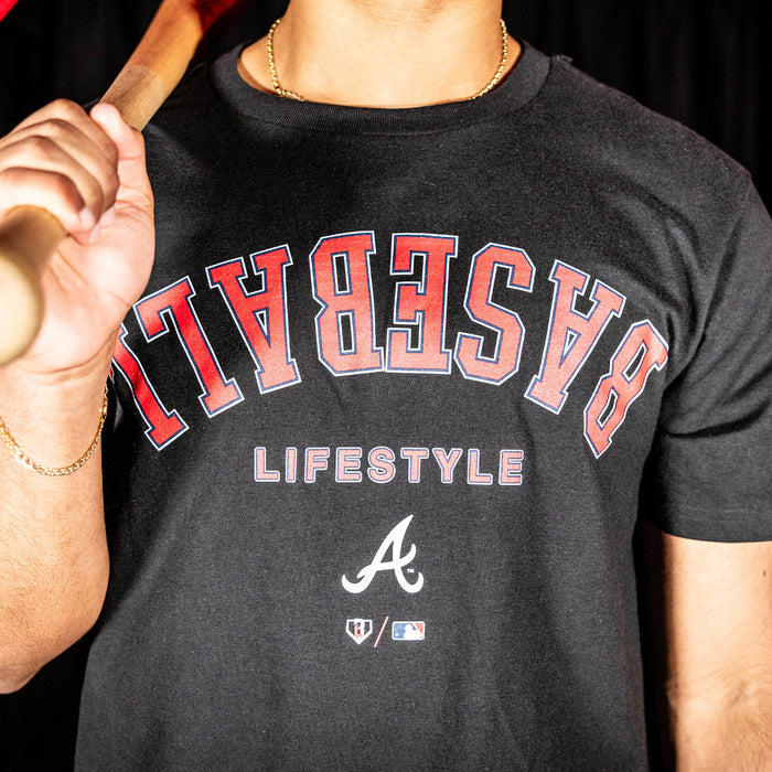 Adult model wearing black graphic tee with "Atlanta Braves Upside Down" design