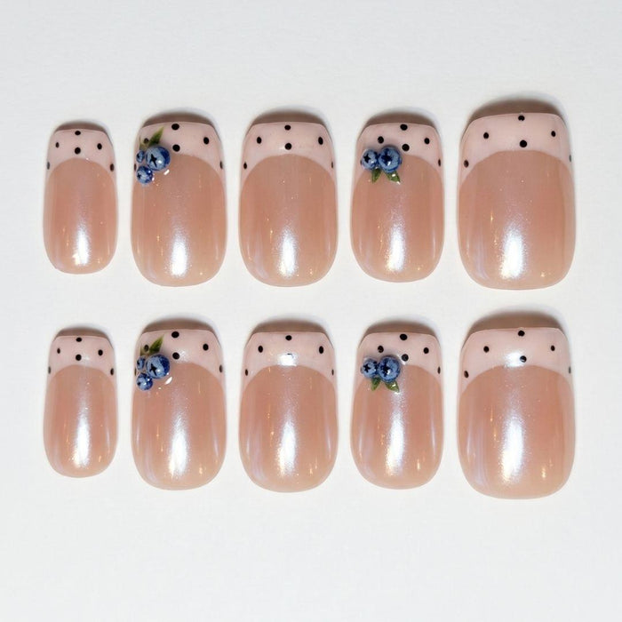 Eyecandys Berry French press-on nails featuring a warm pearlescent nude base, pastel pink French tips, hand-painted blueberry accents, and a short square shape.
