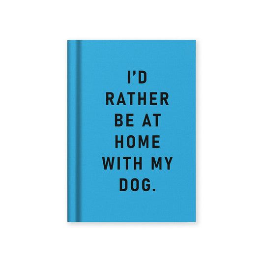 Blue hardback fabric notebook with black "I'd rather be at home with my dog" text