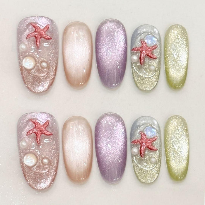 Oval press on nails EyeCandys Mermaid on Duty with multicolor cat eye bases, holographic glitter finish, sculpted red starfish, and moonstone accents.