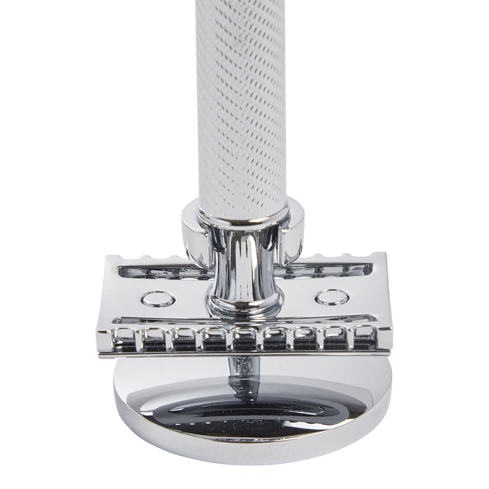 An elegant KirbyAllison.com Muhle Safety Razor Stand with a white handle for a man's bathroom.