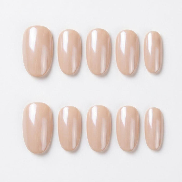 Close-up of Eyecandys Silk Slip reusable press-on nails showcasing a pearlescent champagne pink chrome finish with a glossy glazed shine.
