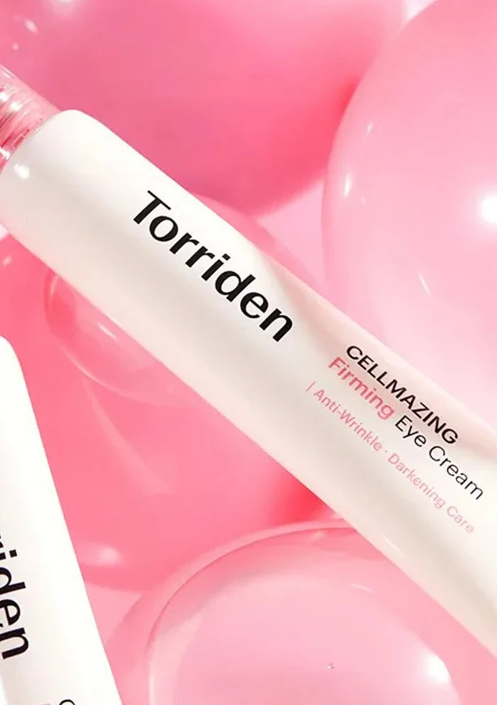 Torriden eye cream bottle on a pink background