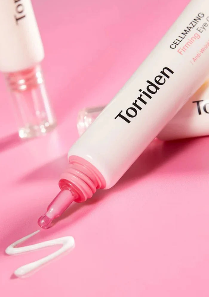 Torriden eye serum with pink cap on a pink background