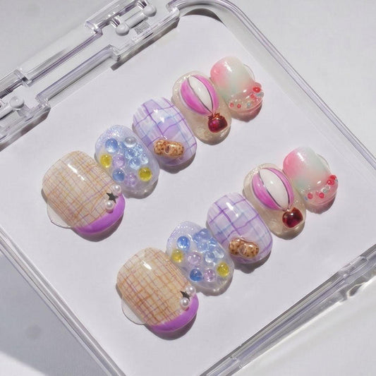 EyeCandys Up Up & Away Press-On Nails feature handmade plaid patterns, pastel gradients, and 3D accents like pearls, gems, and hearts in a clear case for a salon gel manicure look.
